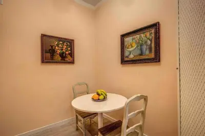 a dining room with a table with a bowl of fruit on it at Casa Vacanze Crispi little 2 in Rome