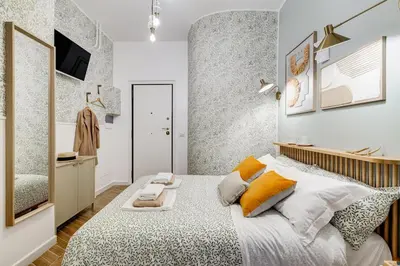a bedroom with a large bed and a mirror at BDC - Love nest! Small but cozy in Rome