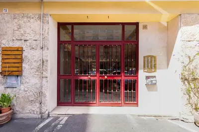 a red door on the side of a building at BDC - Love nest! Small but cozy in Rome