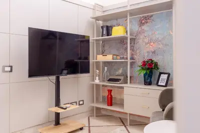 a living room with a flat screen tv on a wall at Oliviero - Piazza Navona Suite in Rome