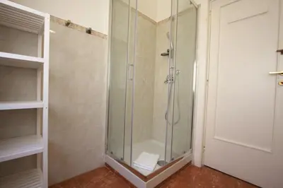 a shower with a glass door in a bathroom at Villa Borghese Holiday House in Rome