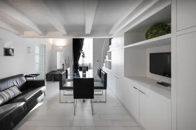 a living room with a couch and a table and a television at LHP Suite Roma Piazza del Popolo in Rome