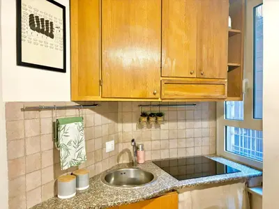 a kitchen with a sink and wooden cabinets at RomeAsYouLike - Colonna Apartment N 50 in Rome
