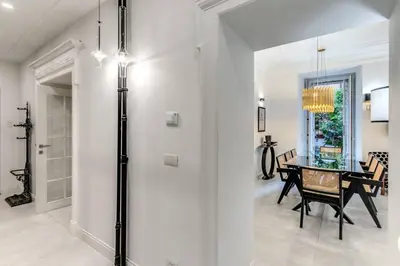a dining room with a dining table and a glass door at Luxury flat with terrace by historic center in Rome