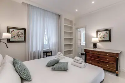 a bedroom with a white bed with towels on it at Luxury flat with terrace by historic center in Rome