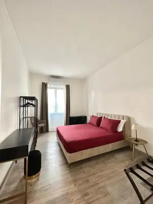 a bedroom with a bed with red sheets and a piano at Rhome in Rome