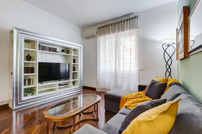a living room with a couch and a tv at BDC - Central charming 2-Bdr! in Rome