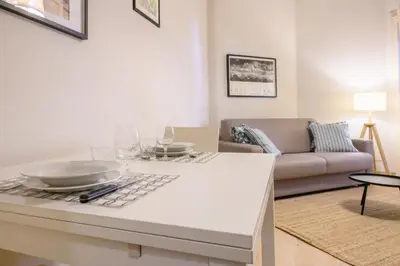 a kitchen with a table with plates and glasses on it at Dreaming in Trastevere in Rome