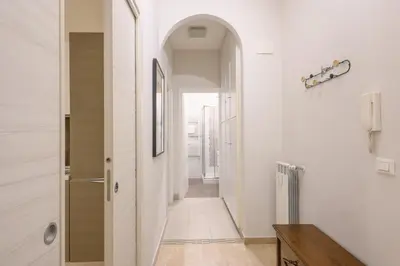 a hallway with white walls and an archway at Dreaming in Trastevere in Rome