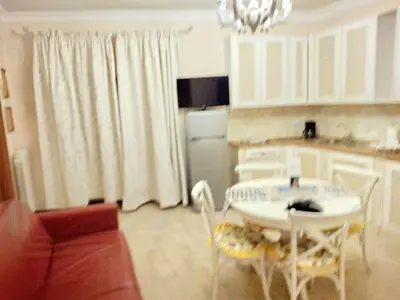 a kitchen with a table and chairs in a room at Firenze 32 at the Opera House in Rome