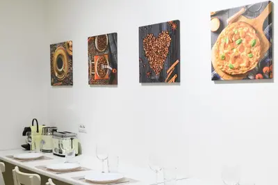 a room with a table with a pizza on the wall at Prosper House in Rome