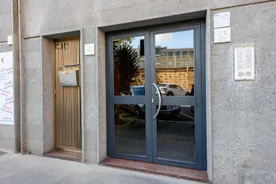 a glass door of a building with a car in it at Prosper House in Rome