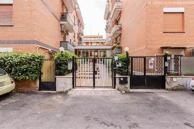 a gate in a parking lot in front of a building at Ferravilla Apt, 2 min to subway! in Rome