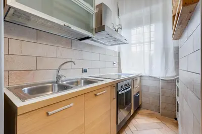 a small kitchen with a sink and a stove at Ferravilla Apt, 2 min to subway! in Rome