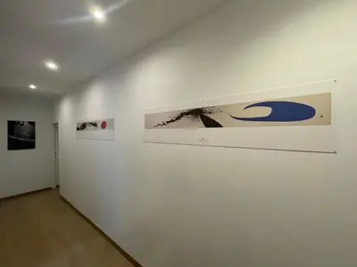 a room with three pictures on a white wall at Theo's House in Rome Ostiense in Rome