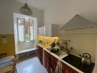 a kitchen with a sink and a stove and a window at Theo's House in Rome Ostiense in Rome