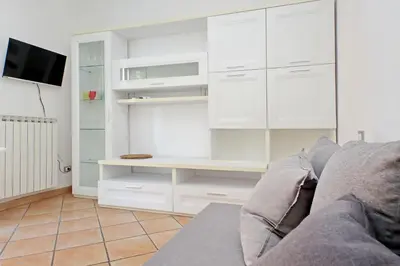 a living room with white cabinets and a couch at Testaccio Sweet Holiday Apt in Rome