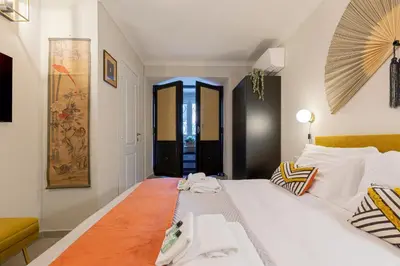 a bedroom with a large white bed in a room at Rome As You Feel - Charming Space at Torre Argentina in Rome