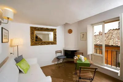 a living room with a white couch and a table at Rooftop view house near Piazza Navona in Rome