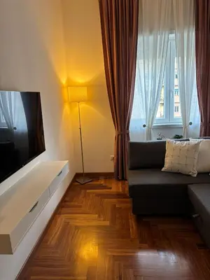 a living room with a couch and a flat screen tv at Gina's House Trastevere Station in Rome