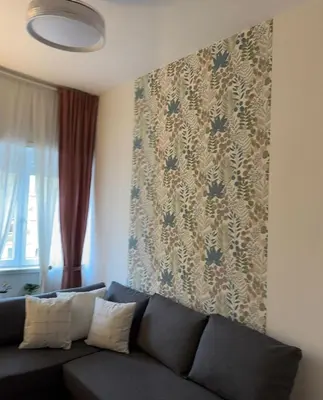 a living room with a couch and a wall at Gina's House Trastevere Station in Rome