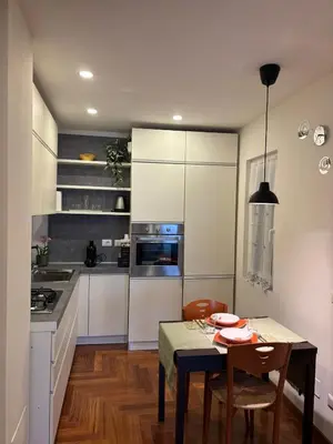 a kitchen with a table and a dining room at Gina's House Trastevere Station in Rome