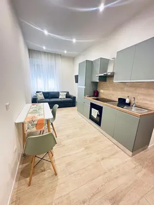 a kitchen and living room with a table and a couch at Bold apartment 2 in Rome