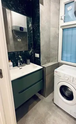 a bathroom with a sink and a washing machine at Bold apartment 2 in Rome
