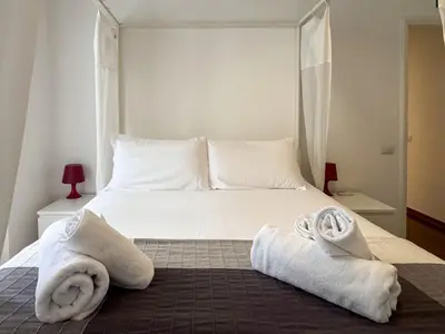 a bedroom with a bed with towels on it at JHHIT - San Pietro First Suite in Rome