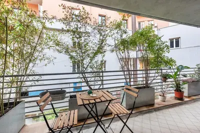 a balcony with chairs and a table and trees at Private Condo Terrace & Parking in Rome