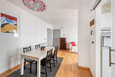a dining room with a white table and chairs at Private Condo Terrace & Parking in Rome