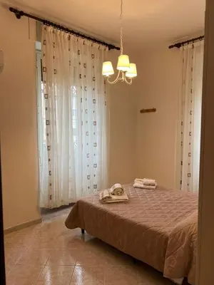 a bedroom with a bed with two towels on it at Villa dei fiori in Rome