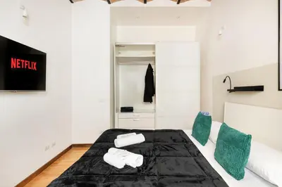 a bedroom with a bed with towels on it at V HOME Termini in Rome