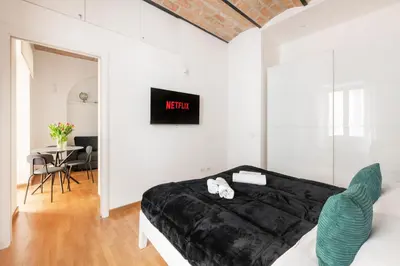a bedroom with a bed and a table with chairs at V HOME Termini in Rome