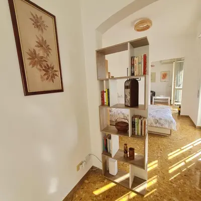 a room with a book shelf and a bed at L' attichetto in Rome