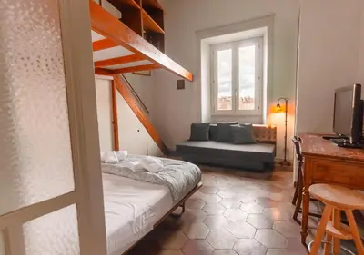 a room with a bed and a couch and a window at Vicino alla Basilica di Santa Maria Maggiore in Rome