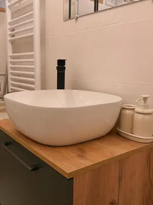 a white sink on a wooden counter in a bathroom at Vacanze Romane House in Rome
