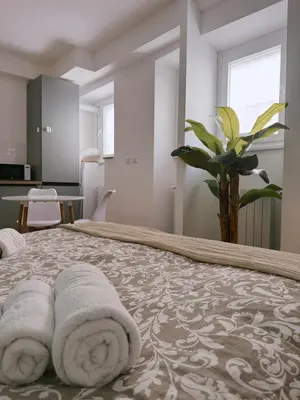 a bedroom with a bed with towels on it at Vacanze Romane House in Rome