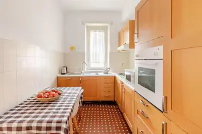 a kitchen with a table with a bowl of fruit on it at Casa Bella in Rome