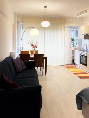 a living room with a couch and a dining room at Domus Lucis Rome in Rome