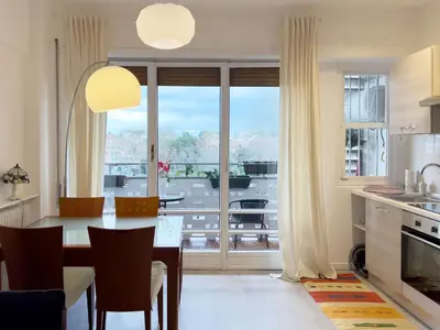 a kitchen and dining room with a table and a large window at Domus Lucis Rome in Rome