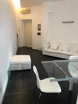a living room with a glass table and white furniture at Vatican 3th Floor in Rome