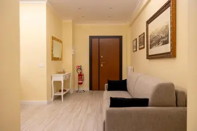 a living room with a couch and a table at Vatican House Crocifisso 51 in Rome