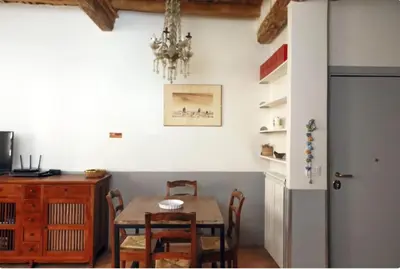 a dining room with a table and chairs and a chandelier at Limani - Campo de' Fiori Private Retreat in Rome