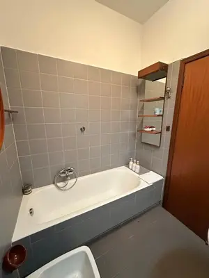 a bathroom with a bath tub and a sink at 6 people, 3 parking spot, balconies, Metro B in Rome