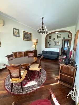 a living room with a table and a couch at 6 people, 3 parking spot, balconies, Metro B in Rome