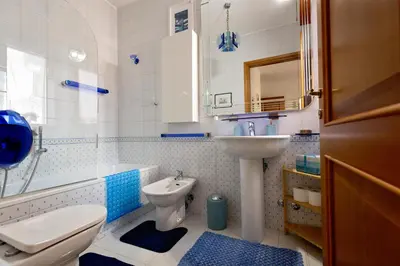 a bathroom with a sink and a toilet and a tub and a sink at Holiday Home Roma in Rome