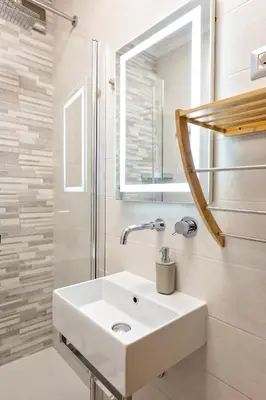 a bathroom with a white sink and a shower at Holiday Home Roma in Rome