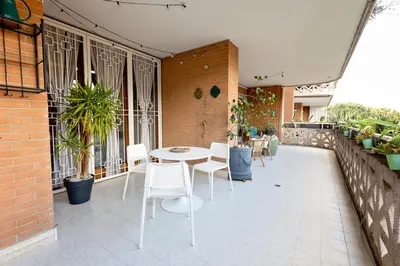 a patio with a table and chairs on a balcony at Holiday Home Roma in Rome