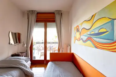 a bedroom with a bed and a painting on the wall at Holiday Home Roma in Rome